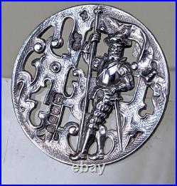 A 1900 silver button depicting a knight with a furled flag in crisp condition